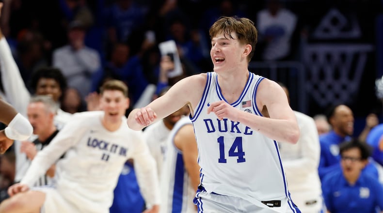 Duke guard Nikolas Khamenia (14) celebrates as Duke defeats Virginia in an NCAA college basketball game in the championship of the Atlantic Coast Conference tournament in Charlotte, N.C., Saturday, March 14, 2026. (AP Photo/Nell Redmond)