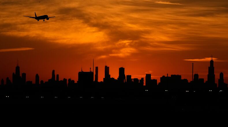 An airplane descends to land at O'Hare International Airport in Chicago, Wednesday, Nov. 12, 2025. (AP Photo/Nam Y. Huh)