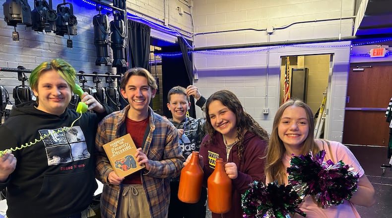 Cast members of the Youth Arts Ambassadors' production of "Beetlejuice Jr." hold some of the creative props that will be used in the show, presented Friday and Saturday at the John Legend Theater. Cast members include, from left, Keith Board, Tyler Barnes, Paxton McKenzie, Addie Powell and Alivia Penwell.