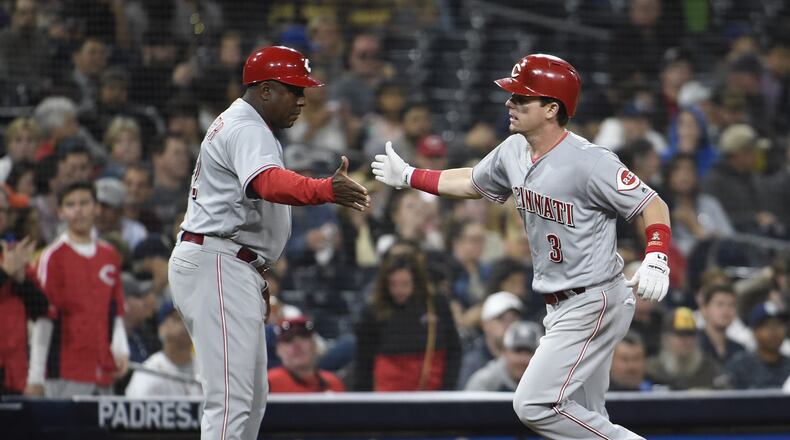 SAN DIEGO, CA - JUNE 1: Scooter Gennett #3 of the Cincinnati Reds is congratulated by Billy Hatcher #22 after hitting a solo home run during the fifth inning of a baseball game against the San Diego Padres at PETCO Park on June 1, 2018 in San Diego, California. (Photo by Denis Poroy/Getty Images)