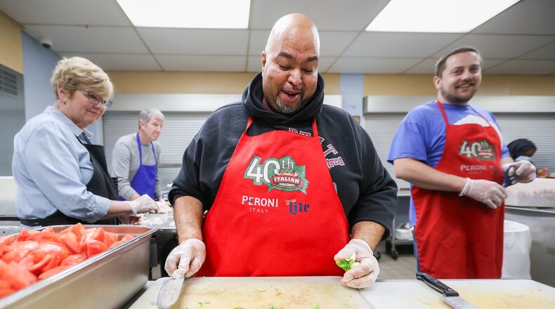 House of Bread volunteer Gregory Nelson laughs shortly after finishing cutting a green pepper before the organization's lunch service on Tuesday, April 15, 2025. People in the region are continuing to experience food insecurity and/or an inability to afford food. House of Bread offers daily hot lunches to people in need.  BRYANT BILLING / STAFF