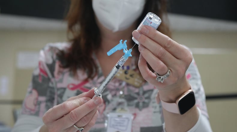Kristen Earley gets a COVID vaccine shot ready at the Clark County Combined Health District's vaccine center last fall. BILL LACKEY/STAFF
