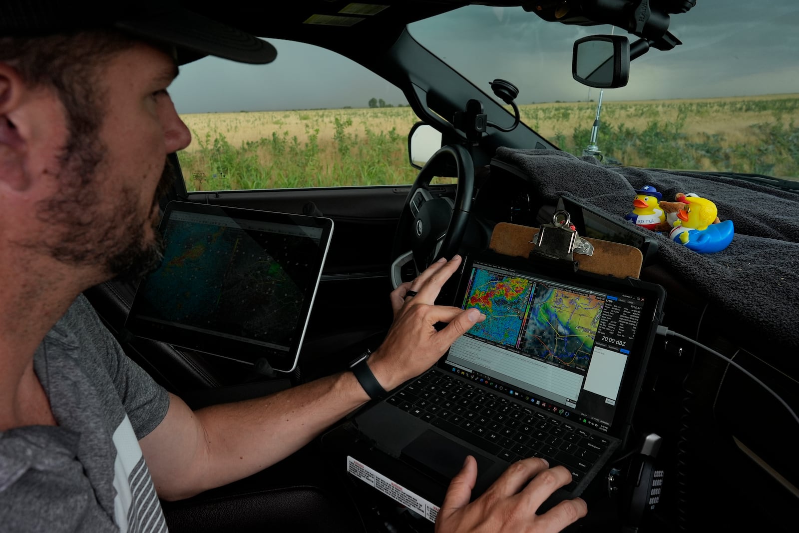 Victor Gensini, Northern Illinois University meteorology professor and a lead scientist of Project ICECHIP, checks storm data in the command vehicle during an operation Tuesday, June 3, 2025, south of Tipton, Okla.(AP Photo/Carolyn Kaster)