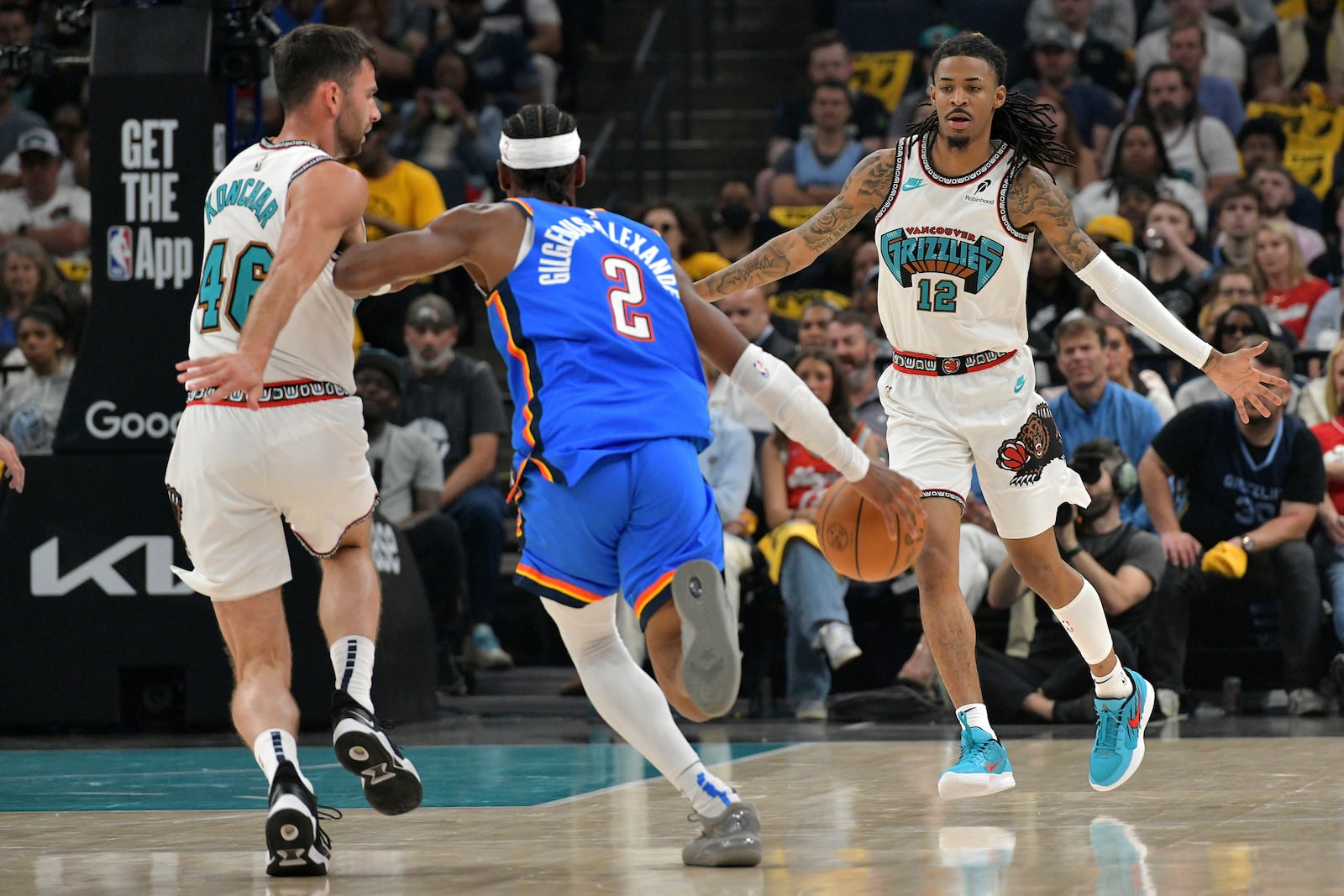 Oklahoma City Thunder guard Shai Gilgeous-Alexander (2) brings the ball upcourt against Memphis Grizzlies guards John Konchar (46) and Ja Morant (12) in the first half of Game 3 of an NBA first-round playoff series Thursday, April 24, 2025, in Memphis, Tenn. (AP Photo/Brandon Dill)