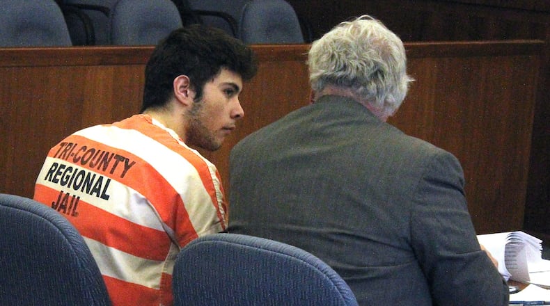 Ely Serna (left) and his attorney Dennis Lieberman talk before a motion hearing in Champaign County Common Pleas Court. JEFF GUERINI/STAFF