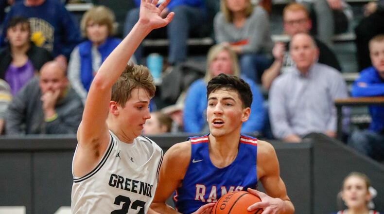 Greeneview’s Cole Allen drives the baseline while being guarded by Greenon’s Mason Potter during their game on Friday night in Enon. The Rams won 54-52. CONTRIBUTED PHOTO BY MICHAEL COOPER