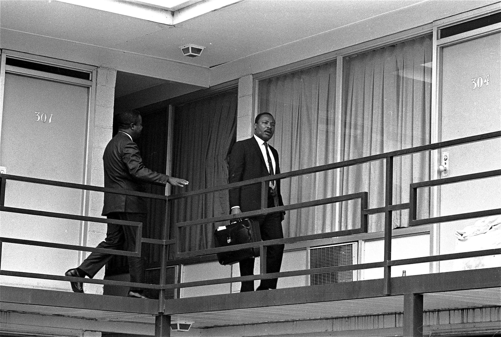 FILE - Rev. Martin Luther King, Jr. walks across the balcony of the Lorraine Motel in Memphis, April 3, 1968. (AP Photo/Charles Kelly, File)