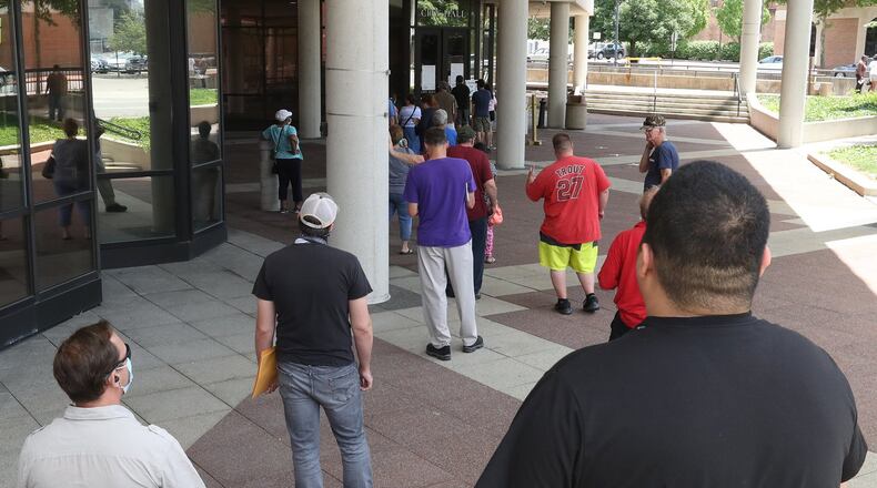 Springfield residents wait in line to file their city taxes at the Springifeld City Hall Tuesday. BILL LACKEY/STAFF