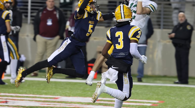 Springfield's Aaron Scott tries to break-up a touchdown pass the St. Edward's Connor Goodall. BILL LACKEY/STAFF