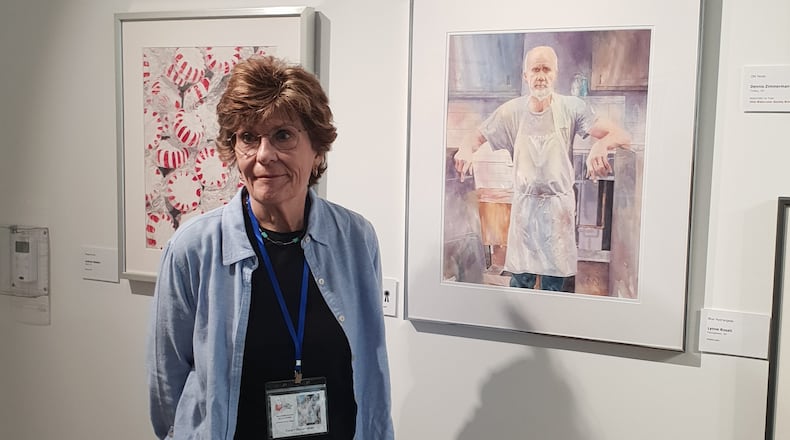 Watercolor artist Nancy Notarianni poses next to her gold medal award-winning piece "Westside Meat Market Man" at a new exhibition at the Springfield Museum of Art. CONTRIBUTED