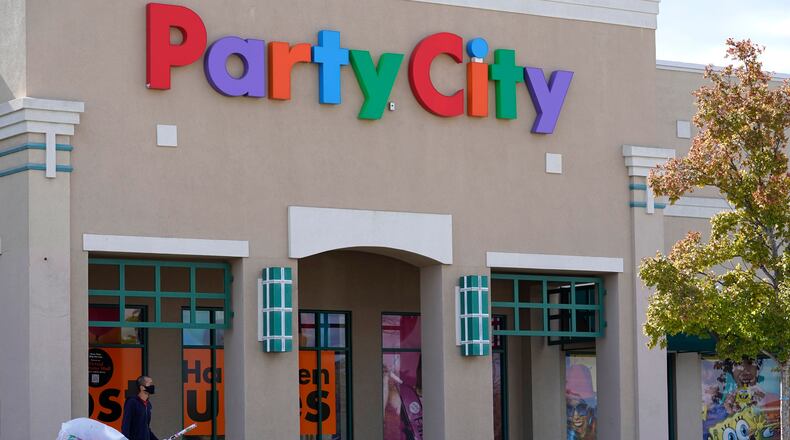 A shopper leaves a Party City store in Vernon Hills, Ill., Thursday, Oct. 15, 2020. The party supplies chain has been long struggling with increased competition from the likes of Walmart and Target. (AP Photo/Nam Y. Huh, File)