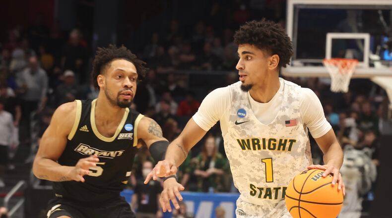 Wright State’s Trey Calvin works around Bryant’s Charles Pride Wednesday, March 16, 2022 during the First Four tournament at UD Arena. BILL LACKEY/STAFF