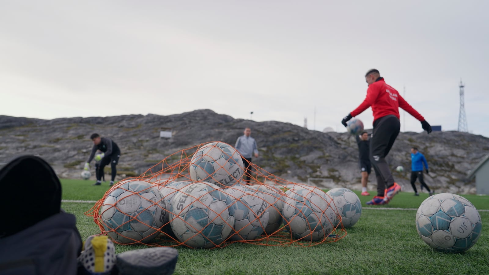 Soccer balls lie on a pitch of Nuuk stadium in Nuuk, Greenland, Tuesday, June 17, 2025. (AP Photo/Kwiyeon Ha)