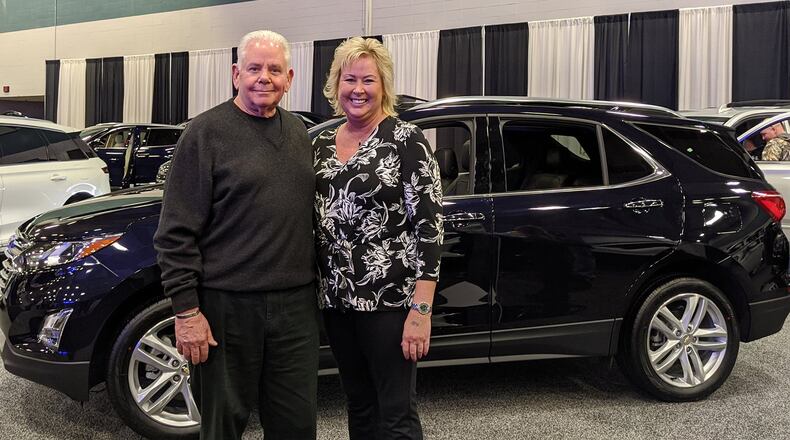Joe Johnson of Joe Johnson Chevrolet, representing the Miami Valley Chevrolet Dealers, presents Darci Aselage of Sidney with the grand prize of a two-year lease on a 2020 Chevrolet Equinox at the 2020 Dayton Auto Show on March 23. The lease has an approximate value of beween $9,000 and $10,000. The Miami Valley Chevy Dealers have offered the prize for several years. This year’s show ran from Feb. 20 to 23, drawing thousands of attendees to the Dayton Convention Center to drool over more than 165 of the latest models and picture themselves behind the wheel of a new car, truck, crossover, hybrid or Harley-Davidson motorcycle. Contributed photo