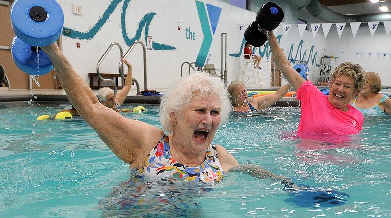 Marilyn Specht, 84, left, works with her instructor Sandy Bakos, during a water exercise class Tuesday Feb. 29, 2023. 
Specht goes 5 times a week to the Kleptz YMCA in Englewood. MARSHALL GORBY\STAFF