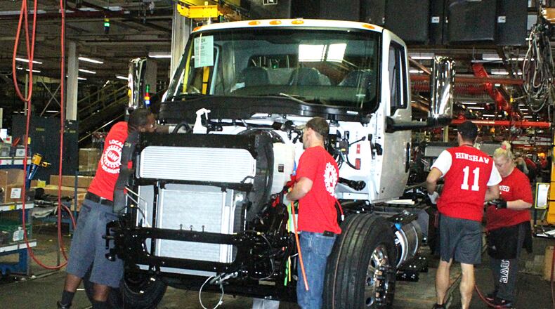 Navistar International employees put together a truck on the assembly line. JEFF GUERINI/STAFF September21 2018