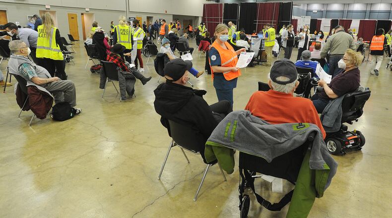 Hundreds of people arrived at the Dayton Convention Center Wednesday morning, Jan. 20, 2021, for the COVID-19 vaccination. MARSHALL GORBY\STAFF