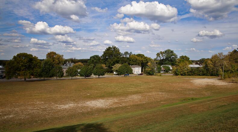 The vacant field at 1315 W. High St. is the site a proposed apartment complex. It once housed Clark Middle School. BILL LACKEY/STAFF