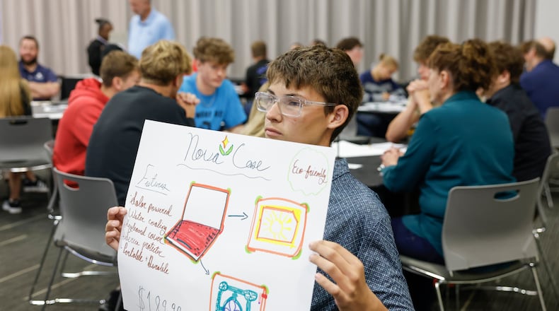 Hayden Sheppeard, a sophomore at Triad High School, shows a poster his group made during an interactive activity at Discovery Day on Tuesday, Sept. 30, 2025, at the Hollenbeck Bayley Center. JOSEPH COOKE/STAFF