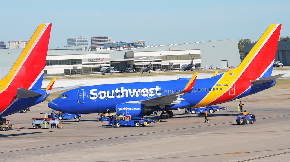FILE - A Southwest Airlines jet pulls into a gate at Dallas Love Field Airport Tuesday, Nov. 11, 2025, in Dallas. (AP Photo/LM Otero, File)
