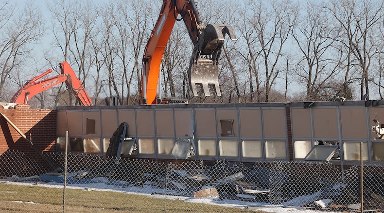 A demolition crew tears down Northridge Elementary/Middle School Monday, Feb. 19, 2024. The school has been empty since the students moved into a combined Kenton Ridge School at the beginning of the school year. BILL LACKEY/STAFF