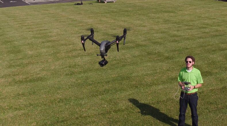 Ethan Schreuder, a survey technician and UAS pilot for Beavercreek-based Woolpert, flies a company unmanned aerial vehicle. Using drones for mapping and surveying has become a part of the company’s daily business. TY GREENLEES / STAFF