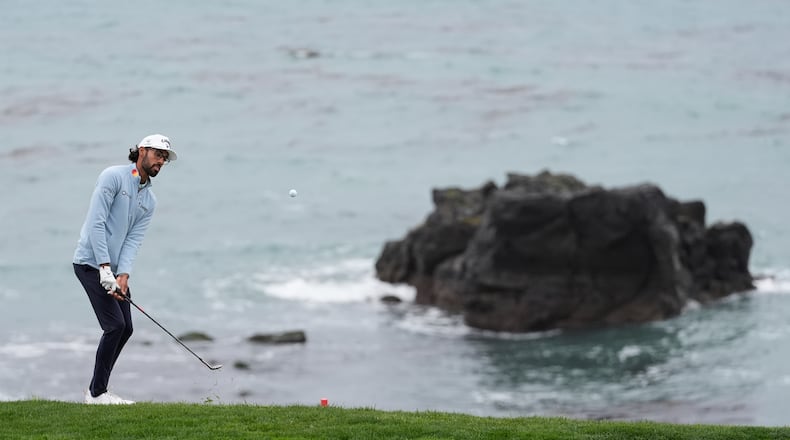Akshay Bhatia putts to the eighth green at Pebble Beach Golf Links during the third round of the AT&T Pebble Beach Pro-Am golf tournament, Saturday, Feb. 14, 2026, in Pebble Beach, Calif. (AP Photo/Godofredo A. Vásquez)
