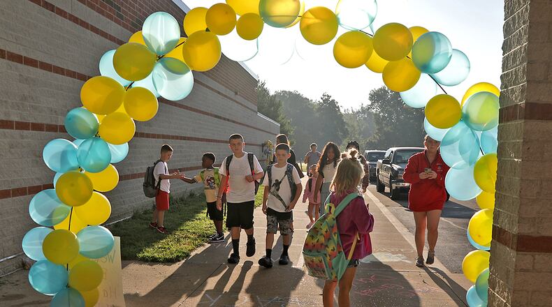Students at Warder Park-Wayne Elementary School walk into school for the first day of school Wednesday, August 24, 2022. BILL LACKEY/STAFF