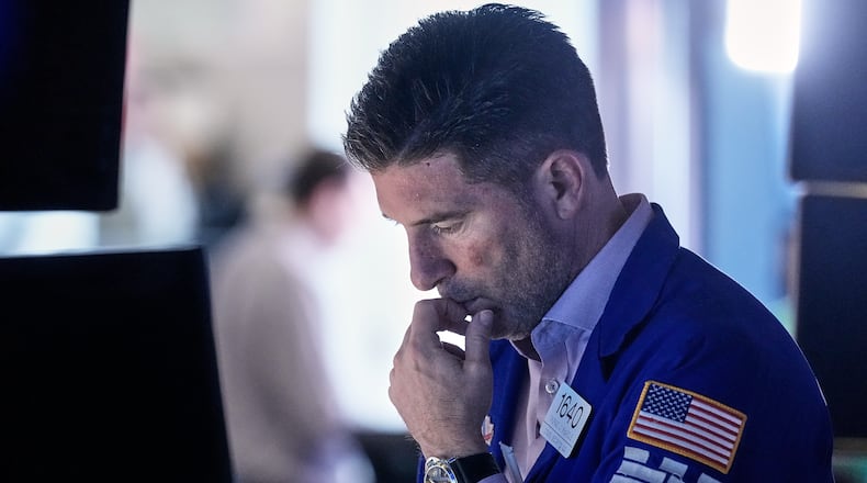 Specialist Thomas McArdle works at his post on the floor of the New York Stock Exchange, Friday, Feb. 20, 2026. (AP Photo/Richard Drew)