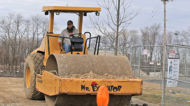 A worker drives an roller at the construction site of the new QuickTrip location near the intersection of South Limestone Street and Leffel Lane Friday, March 7, 2025. The Ohio Department of Medicaid submitted a request to the U.S. Centers of Medicare and Medicaid Services to implement work requirements for certain Medicaid enrollees in the expansion group as the federal government weighs significant cuts to the program nationally, both of which could result in people losing their health insurance. BILL LACKEY/STAFF
