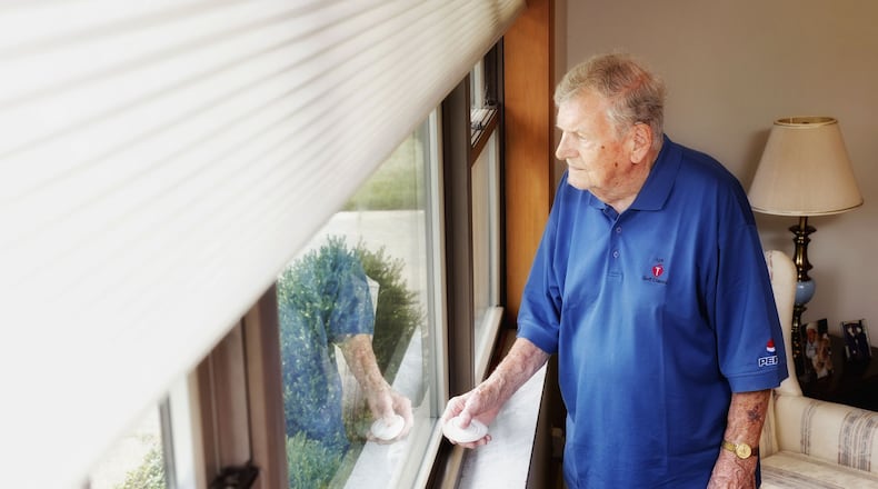 Hal Pearce uses remote controlled window shades in his home in Middletown. The controller makes it easy to raise and lower the shades with the push of a button. NICK GRAHAM/STAFF
