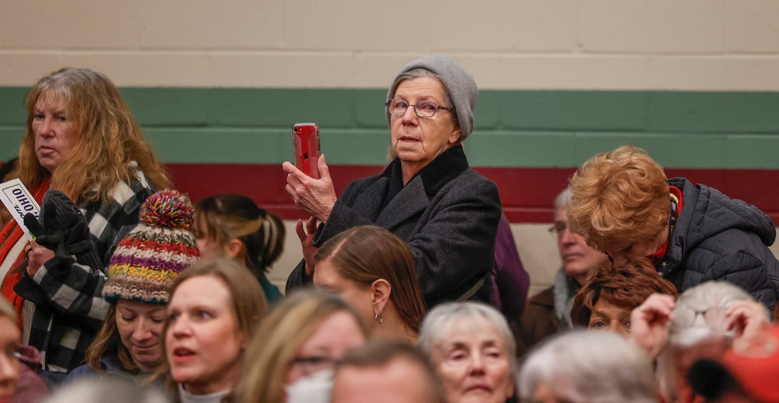 An audience member films the estimated 1,200 attendees of Here We Stand: Faith Leaders for Immigration Justice & Family Unity at St. John Missionary Baptist Church on Monday, Feb. 2, 2026, in Springfield. The venue was over capacity as pastors, faith leaders and community members gathered to pray and call for the extension of Temporary Protected Status, which is scheduled to expire on Tuesday, Feb. 3, 2026. JOSEPH COOKE/STAFF