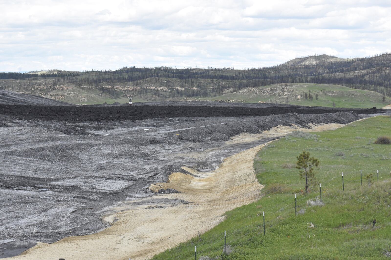 Waste material from Signal Peak Energy's Bull Mountains coal mine is seen along a rural road, on May 21, 2025, near Roundup, Montana. (AP Photo/Matthew Brown)