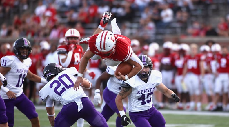 Wittenberg's Garrett Gross falls after attempting to hurdle a Kenyon defender on Saturday, Sept. 16, 2023, at Edwards-Maurer Field in Springfield. David Jablonski/Staff