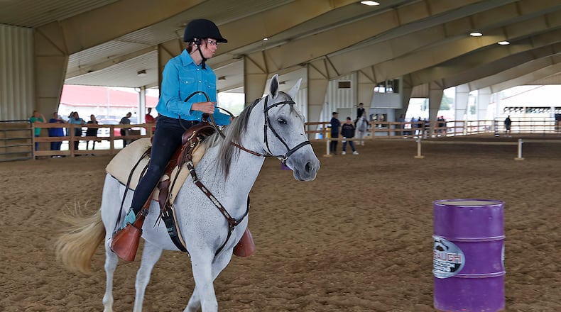 File - Elizabeth Burgoon, one of the athletes in the 2023 Special Olympics State Equestrian Meet, competes on her horse "Saddle" in the barrel racing event on Sept. 9, 2023 at the Champions Center at the Clark County Fairgrounds. The event will be returning Sunday, Aug. 24, 2025, to the Champions Center for the 2025 Special Olympics Ohio Equestrian Games, which is also celebrating its 50th anniversary. STAFF