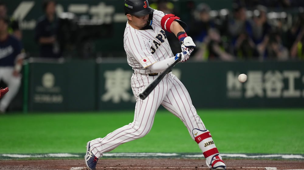 Japan's Seiya Suzuki hits a two-run home run during the first inning of a World Baseball Classic game between Japan and South Korea on Saturday, March 7, 2026 in Tokyo, Japan. (AP Photo/Hiro Komae)