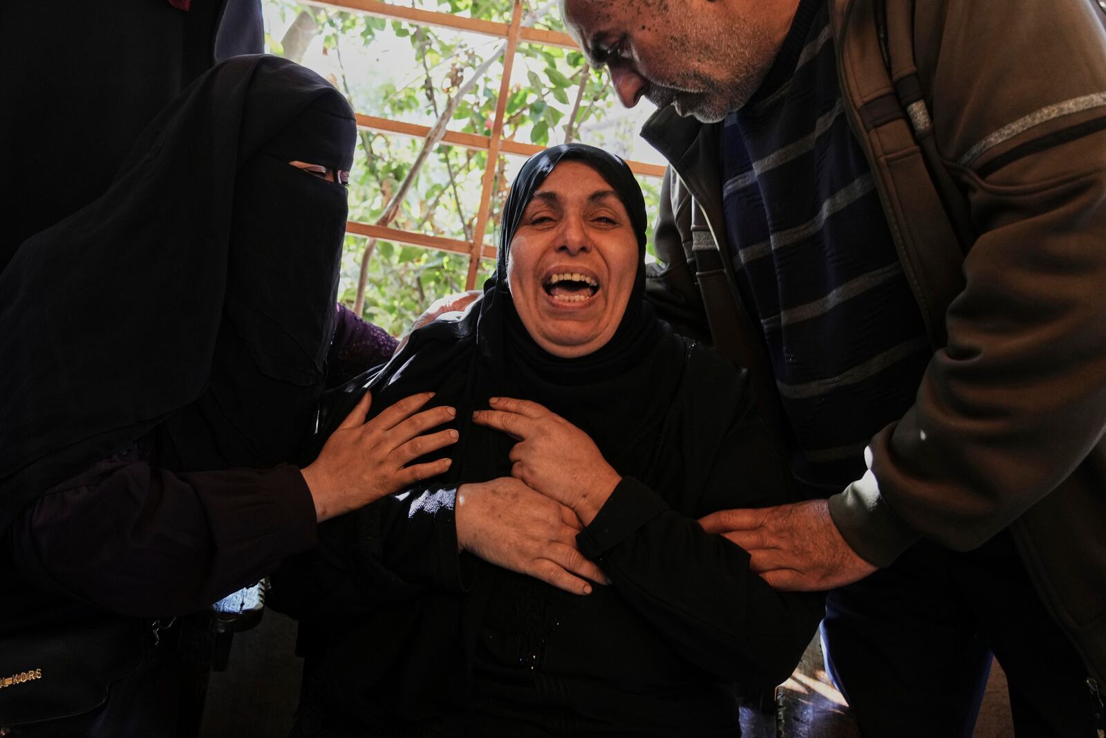 A Relative of 10 members of the Abu Al-Rous family, killed when an Israeli airstrike struck their displacement tent overnight, reacts during their funeral in Khan Younis, southern Gaza Strip, Thursday, April 17, 2025. (AP Photo/Abdel Kareem Hana)