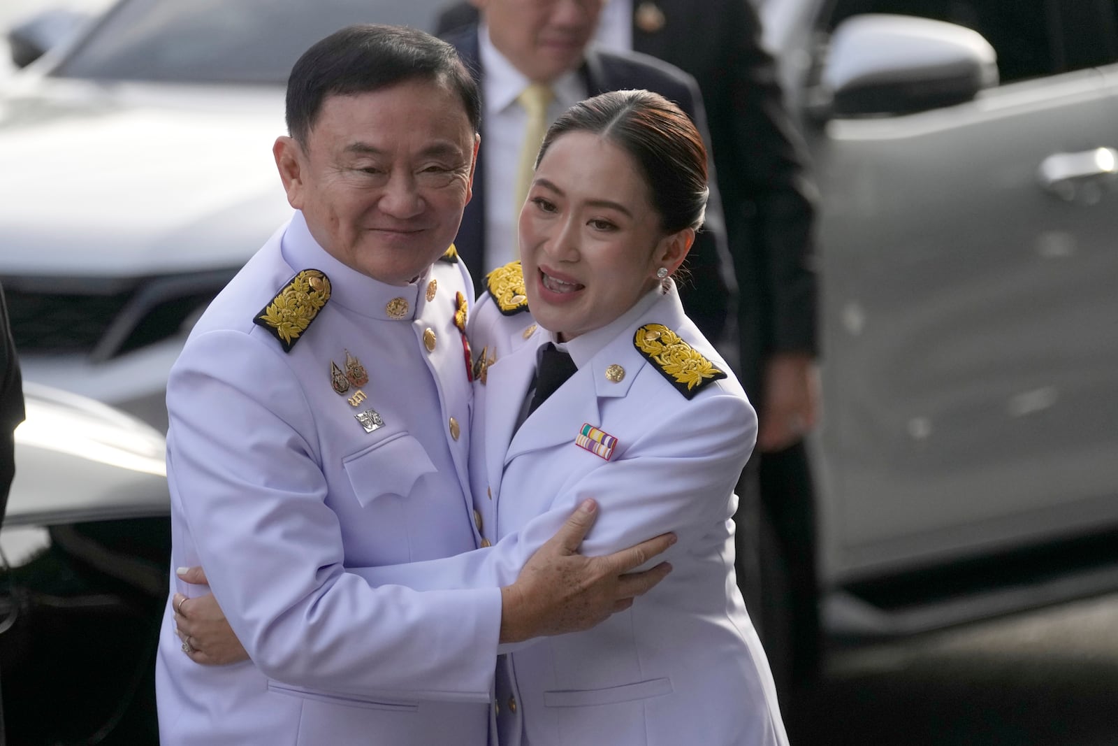 FILE - Thailand's former Prime Minister Thaksin Shinawatra, left, hugs his daughter and newly elected Prime Minister Paetongtarn Shinawatra before the royal endorsement ceremony appointing Paetongtarn as Thailand's new prime minister at Pheu Thai party headquarters in Bangkok, Thailand, on Aug. 18, 2024. (AP Photo/Sakchai Lalit, File)