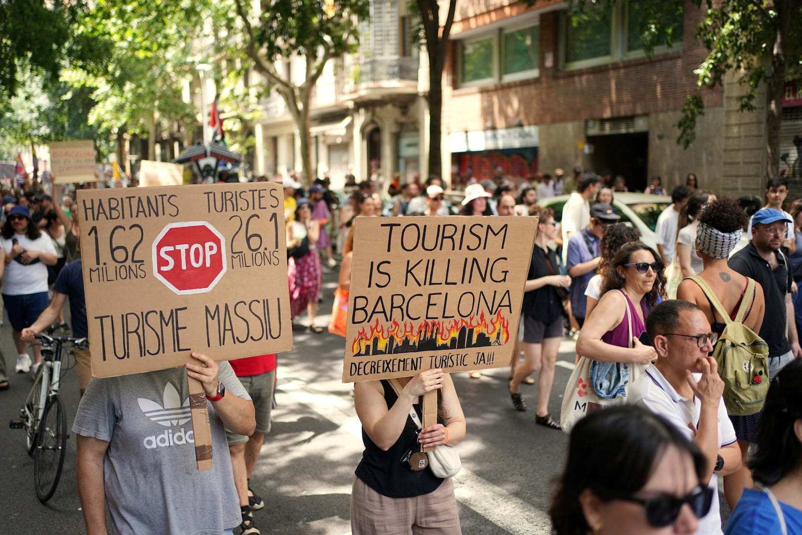People march during a protest against overtourism in Barcelona, Spain, Sunday, June 15, 2025. (AP Photo/Pau Venteo)