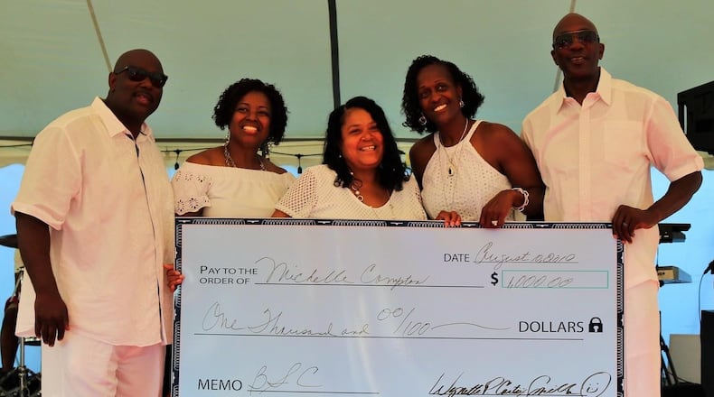 Michelle Compton, center, received a scholarship in 2019 from the Bass Smith Connection, which raises funds for scholarships for African American students. On the left are Vernon and Sunna Bass and on the right are Nettie (Carter) and Jamel Smith; these friends founded the nonprofit Bass Smith Connection. They'll award 2020 scholarships to students at a celebration event on Saturday. Contributed photo