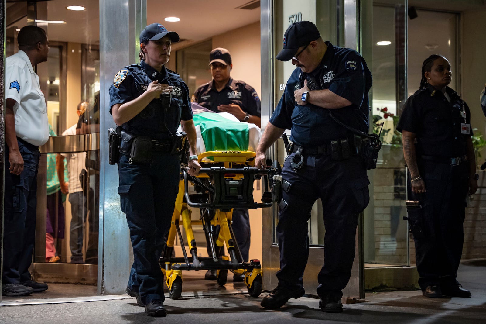 NYPD officers bring out the body of Didarul Islam, who was shot and killed by a gunman earlier this evening, during his dignified transfer of out of NewYork-Presbyterian/Weill Cornell Medical Hospital to the medical examiner's office, early Tuesday, July 29, 2025, in New York. (AP Photo/Angelina Katsanis)