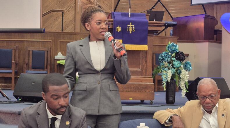 Ohio State Rep. Desiree Tims speaks during a town hall meeting at the Shiloh Baptist Church Sept. 16 while Ohio State Sen. Willis Blackshear, Jr., (left) and Dayton Mayor Jeffrey Mims listen. MICHAEL KURTZ / STAFF