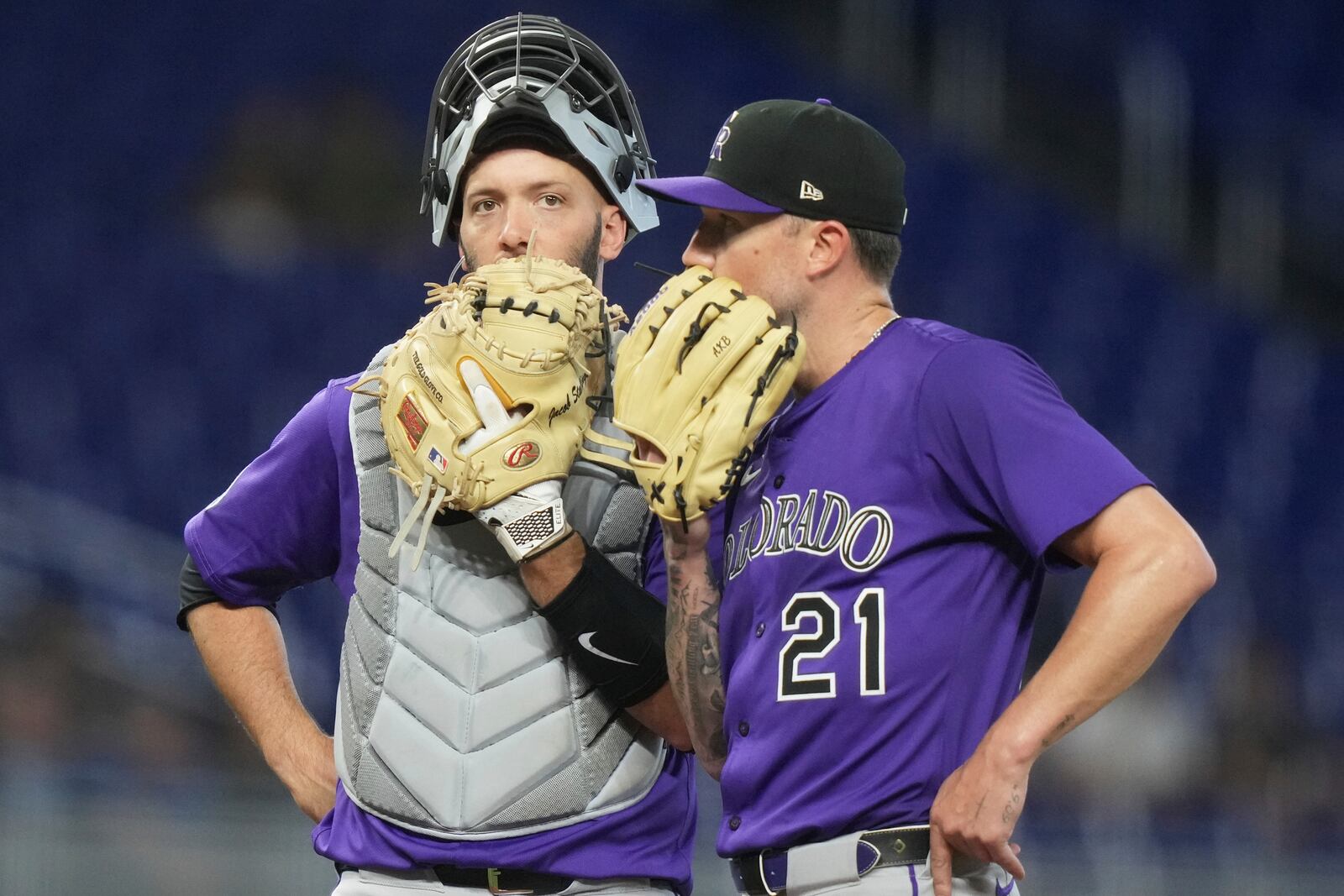 Colorado Rockies catcher Jacob Stallings, left, and starting pitcher Kyle Freeland (21) talk on the mound during the seventh inning of a baseball game against the Miami Marlins, Wednesday, June 4, 2025, in Miami. (AP Photo/Lynne Sladky)