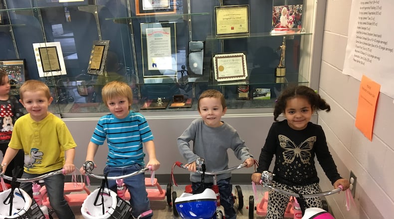Clark Early Learning Center preschool students, from left, Jacob Levering, Mason Hastings, Saarek Harmon and Kyleigh Richard enjoy new tricycles donated to the school by PNC Bank. Brett Turner/Contributed