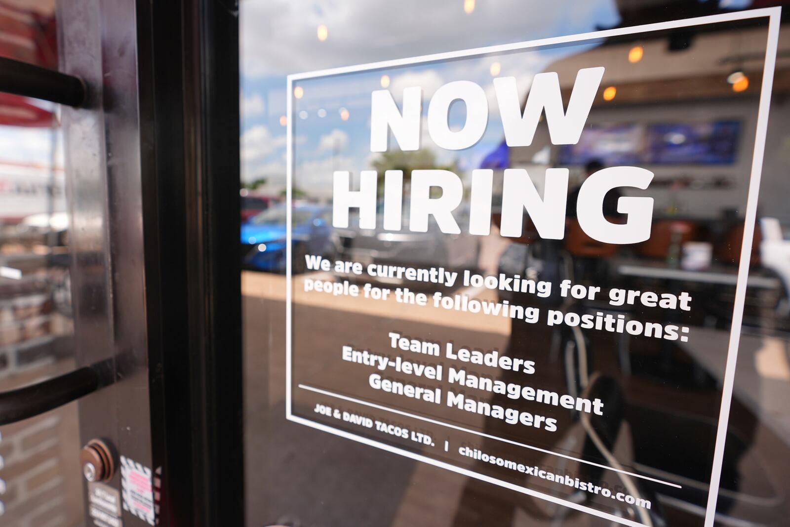 A sign announces a restaurant is hiring workers, Tuesday, July 15, 2025, in Richardson, Texas. (AP Photo/LM Otero)
