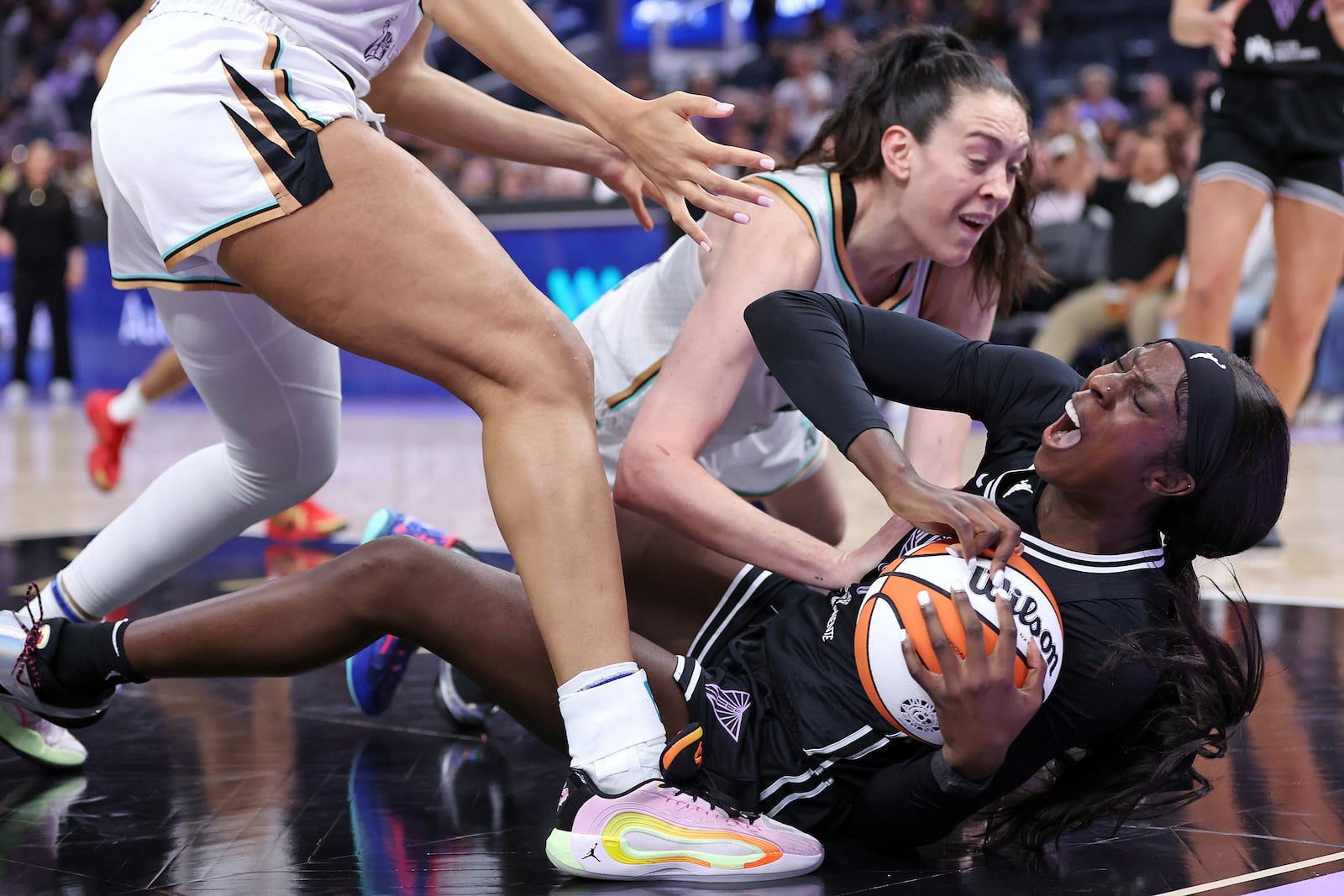 Golden State Valkyries' Laeticia Amihere, bottom, is fouled by New York Liberty's Breanna Stewart during an WNBA basketball game in San Francisco on Wednesday, June 25, 2025. (Scott Strazzante/San Francisco Chronicle via AP)