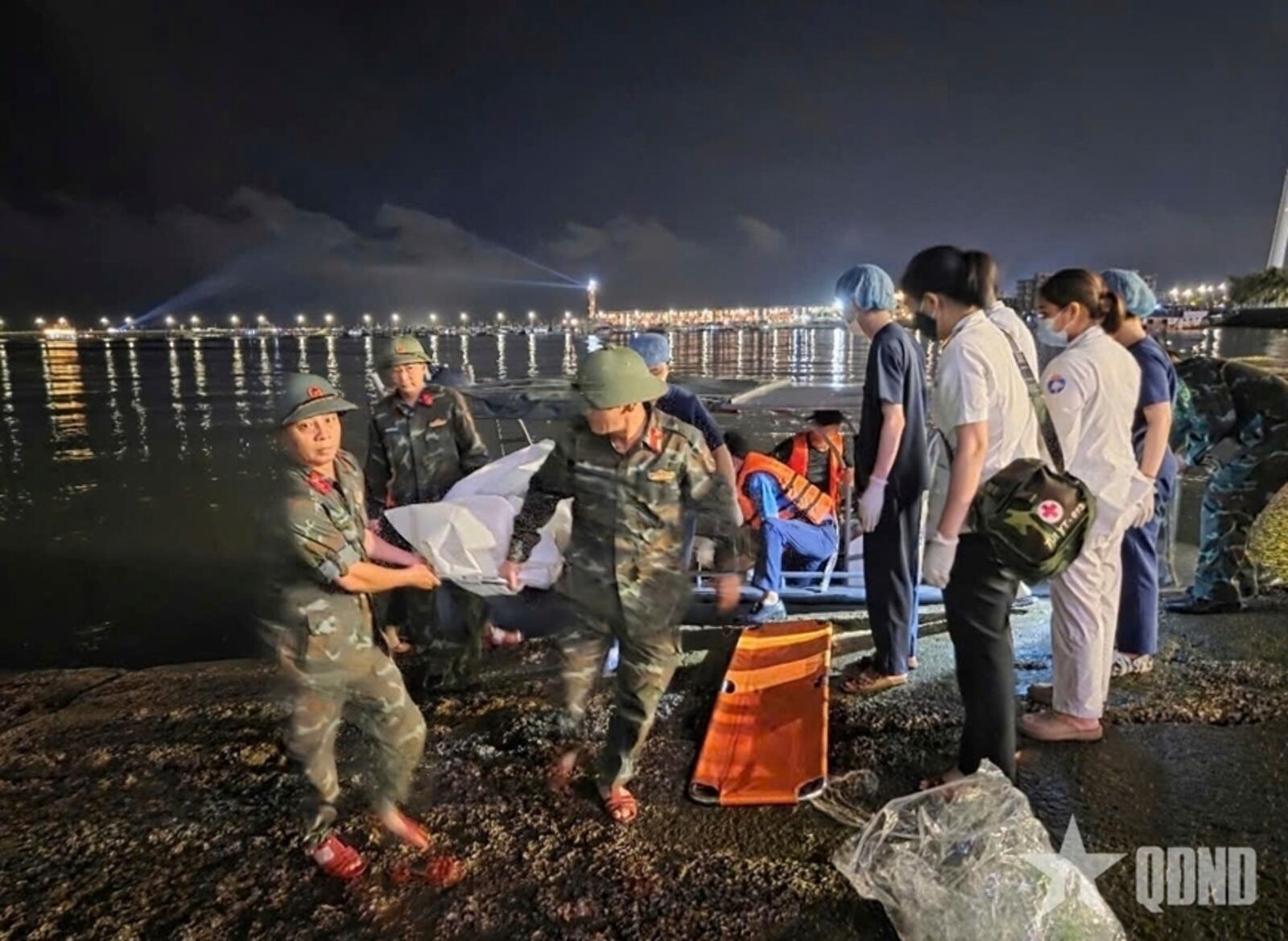 This image from a video provided by QDND shows a body being carried on stretcher after a tourist boat capsized in Ha Long Bay, Vietnam on Saturday, July 19, 2025. (QDND via AP)