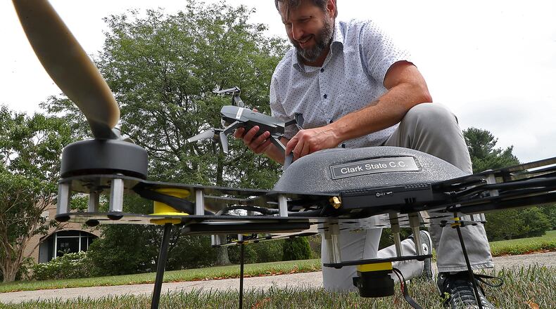 Adam Parrillo talks about the different style drones that students would get the chance to work with at Clark State. BILL LACKEY/STAFF