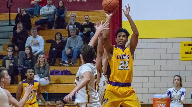 Emmanuel Christian Academy senior Adonis Davis shoots the ball over a Northeastern defender during their game on Tuesday, Dec. 4. The Lions won 79-45. CONTRIBUTED PHOTO BY MICHAEL COOPER