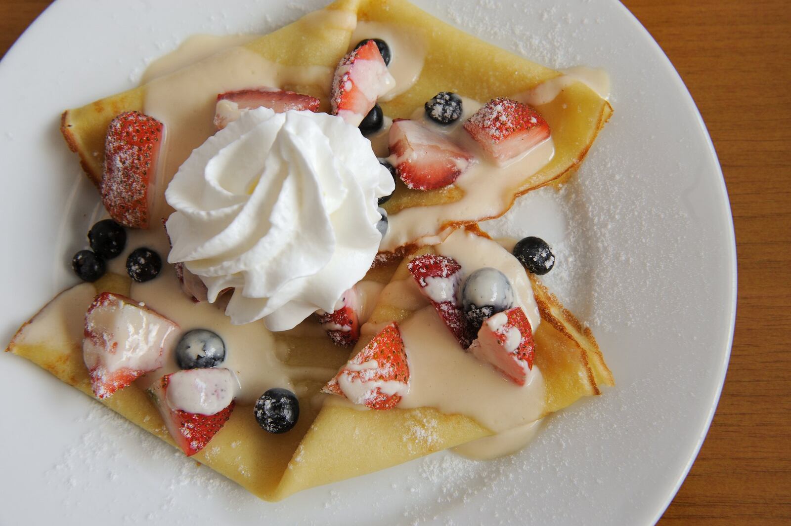 Crepe Romanoff - 2 warm French pancakes, vanilla powder sugar and Brandy Romanoff sauce. Topped with berries and whipped cream.(Beckysteinphotography.com)